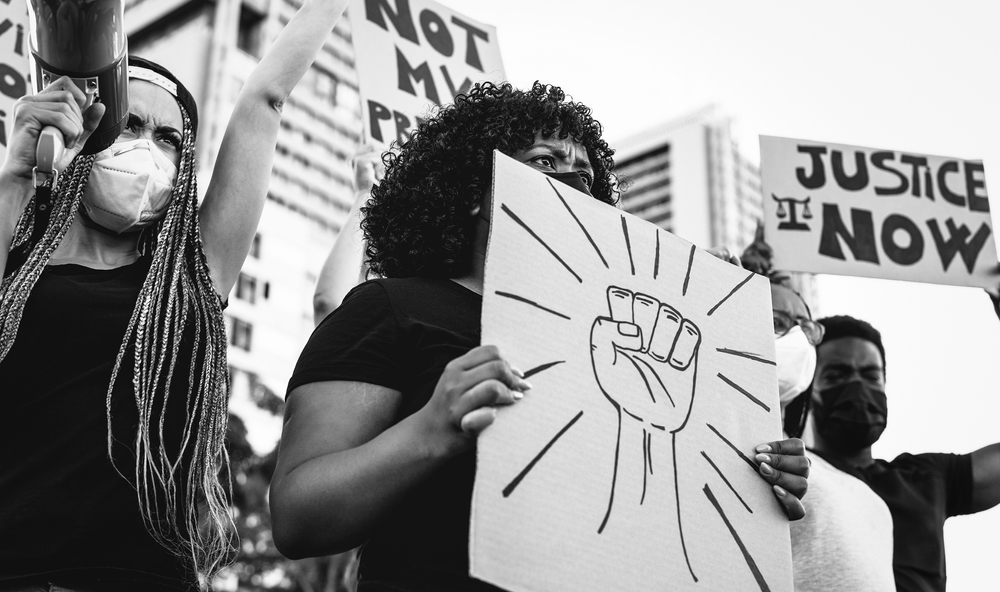 people at protest holding signs